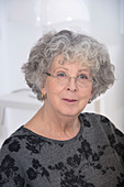 Woman wearing eyeglasses with grey hair