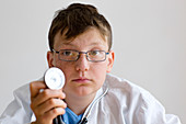 Boy holding a stethoscope