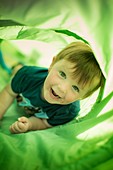 Boy in green tunnel