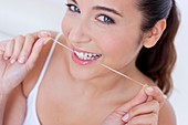 Woman flossing teeth