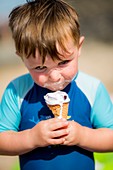 Young boy eating an ice cream