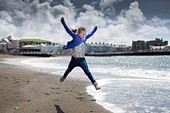 Girl leaping on beach