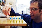 Researcher with vials of DNA BioBricks