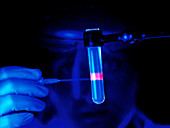 Technician removing DNA sample from a test tube