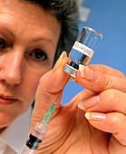 Syringe used to draw interferon drug from a vial