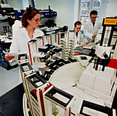 Scientists with automated immunochemical analyser