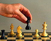 Hand moving a piece during a game of chess