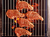 Lamb chops with rosemary,cooking on a barbecue