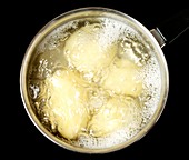 Potatoes boiling in a pan