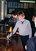 Pupils heating iron filing in chemistry class
