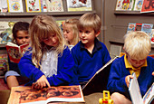 Young schoolchildren reading books