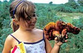 Child holding fungi
