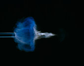 High speed photograph of bullet leaving gun