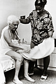 Home care helper assisting an Alzheimer's sufferer