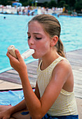 Girl with asthma uses a volumatic inhaler adaptor