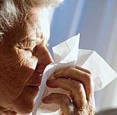Elderly woman sneezing