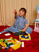 Four year old girl with Down's syndrome playing