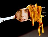 Anorexia nervosa: girl reflected in fork with food