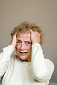 Upset elderly woman