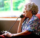 Loneliness: elderly woman makes a telephone call