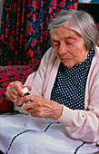 Elderly woman with bottle of tablets