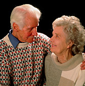 Elderly couple in each other's arms