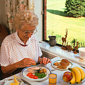 Elderly woman eating healthy meal