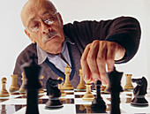 Elderly man plays a game of chess