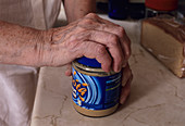 Elderly woman opening jar