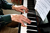 Elderly man playing the piano