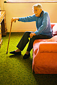 Elderly man sitting on a sofa