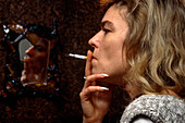 Side view of a woman smoking a cigarette