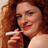Woman holds a Nicorette nicotine drug inhaler