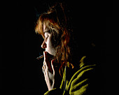 Woman smoking a tobacco cigarette