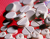 Close-up of large and small tablets of ecstasy