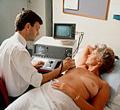 Ultrasound breast examination being performed