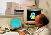 Radiographer performing a PET brain scan
