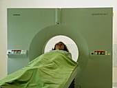 Patient passes into a CT scanner