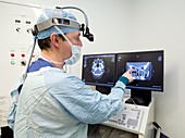 Surgeon studying CT scan