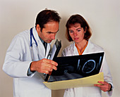 Two doctors analyse the results of an MRI scan