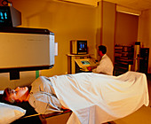 Woman undergoing bone gamma scan to detect cancer
