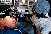 Doctor using bronchoscope to examine trachea