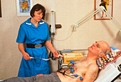 ECG heartbeat test: nurse monitors an elderly man