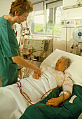 Nurse conforts a patient during kidney dialysis