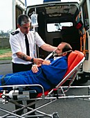 Ambulanceman adjusting patient's oxygen mask