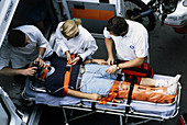 Patient being loaded into an ambulance