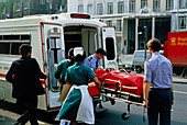 Man in stretcher put in ambulance in emergency