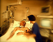 Nurse with an elderly patient in intensive care