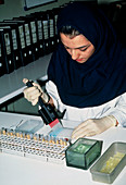 Technician carrying out an ELISA antibody test