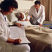 Nurse and doctor with elderly patient